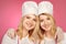 Pretty blonde twins posing for double portrait as bakers