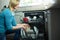 Pretty blonde woman emptying the dishwasher