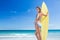 Pretty blonde woman holding surf board