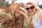 Pretty blonde woman pets a baby elephant in Nairobi Kenya