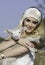 Pretty blonde woman with white crochet headband holding little lamb