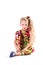 Pretty blondie six years old small girl  in colorful jumpsuit on white background sitting