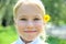 Pretty blone girl outdoors with flower behind ear