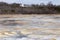 Pretty blue, brown and white colourful surface patches in the early spring thawing LÃ©on-Provencher marsh