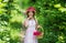 pretty bouquet. gather flower bouquet in basket. happy teen girl in straw hat. childhood happiness.