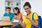 Pretty brazilian female students with group of computer science students