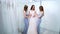 Pretty bride and bridesmaids wearing dresses in wedding salon