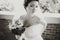 Pretty bride grimaces while holding a bouquet