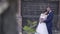 Pretty bride in long dress leans on husband slow motion