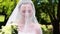 Pretty bride smiling at camera with veil over her face