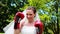 Pretty bride smiling at camera and wearing boxing gloves