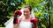 Pretty bride smiling at camera and wearing boxing gloves