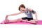 Pretty brunette doing the hamstring stretch on exercise mat