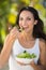 Pretty brunette eating bowl of salad