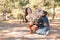 Pretty brunette girl and a little boy walking with dog in the park. Animal concept.