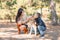 Pretty brunette girl and a little boy walking with dog in the park. Animal concept.