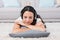 Pretty brunette lying on the rug listening to music