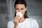 Pretty brunette woman cleansing nose with sponge.
