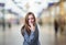 Pretty business woman making vomiting gesture over blur background.