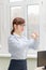 pretty business woman in strict stylish clothes and glasses in the office near the desktop crumples documents