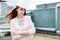 Pretty businesswoman in beige suit stand on the roof