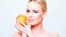 Pretty Caucasian Blond Girl Holding Orange Fruit