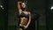 Pretty caucasian fitness woman pumping up muscles workout fitness and bodybuilding concept gym background abs exercises in gym nak