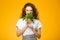 Pretty caucasian girl with curly hair holding green parsley