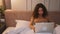 Pretty caucasian woman working laptop on bed at home. focused woman work laptop.