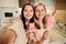 Pretty cheerful females making selfie while having homemade strawberry icecream