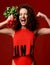 Pretty cheerful young sport strong woman posing with fresh radish green leaves screaming