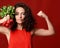 Pretty cheerful young sport woman posing with fresh radish green