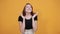 Pretty cheerful young woman in black shirt, smilling, keeping hands, shook head