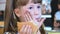 Pretty child girl eating fast food at restaurant.