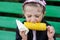 Pretty child girl eats a boiled corn