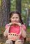 Pretty child girl with mushroom basket in the forest