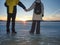 Pretty couple have fun on beach. Winter walk at frozen sea