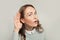 Pretty curious nosy woman listening on white background