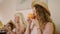 Pretty curly girl smiling and drink coffee in tropical cafe. Young caucasian woman posing, having fun at the restaurant