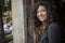 Pretty Curly Haired Woman in Restaurant Doorway