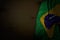 Pretty day of flag 3d illustration - dark photo of Brazil flag with big folds on dark wood with free place for content