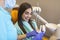 Pretty dentist doctor woman brushing jaw model at dental clinic, dental care concept. Dental care concept. Young woman dentist