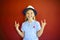 Pretty emothional children wear a hat on a red background