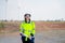 Pretty engineer or technician woman worker hold drawing paper and look at camera with smiling also stand in front of windmill