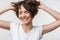 Pretty excited happy woman posing isolated over white wall background laughing