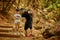 Pretty family dad and little cute daughter hiking in a forest, looking at a map and pointing with hand.