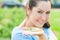 Pretty farm lady holding small ripe cucumbers