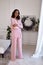 Pretty fashion beautiful woman sexy lady brunette curly hair dark tanned skin wear trend clothes knitted pink pink suit jacket top