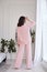 Pretty fashion beautiful woman sexy lady brunette curly hair dark tanned skin wear trend clothes knitted pink pink suit jacket top