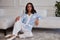 Pretty fashion beautiful woman sexy lady brunette curly hair dark tanned skin wear trend clothes knitted suit blue jacket white